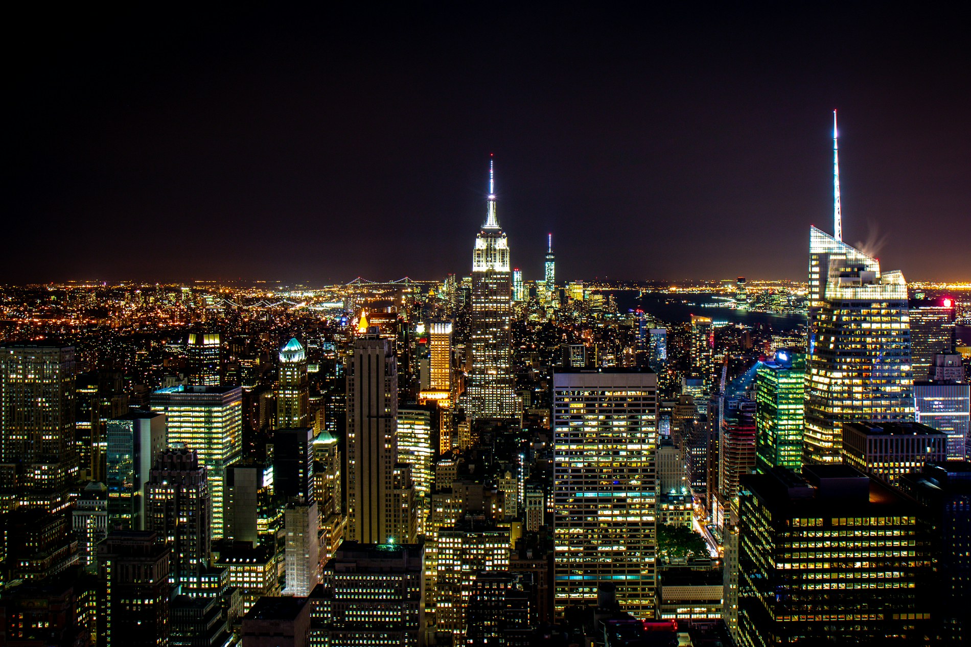The Manhattan skyline at night, the Empire State Building lit gold